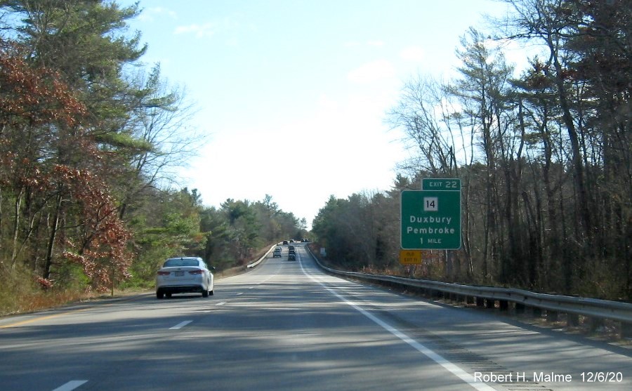 Image of 1 mile advance ground mounted sign for MA 14 exit with new milepost based exit number and yellow old exit sign on left support post on MA 3 South in Duxbury, December 2020