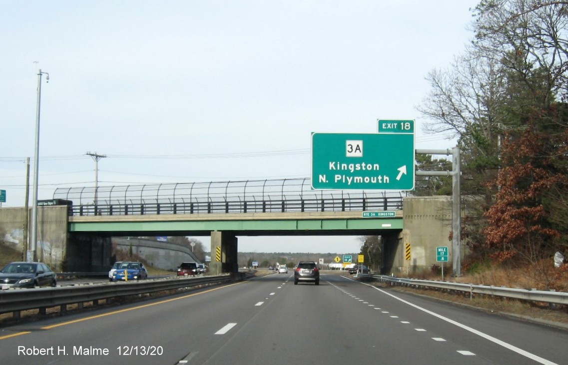 Image of 1-mile advance overhead sign for MA 3A exit with new milepost based exit number and yellow old exit number sign on support post on MA 3 North in Kingston, December 2020