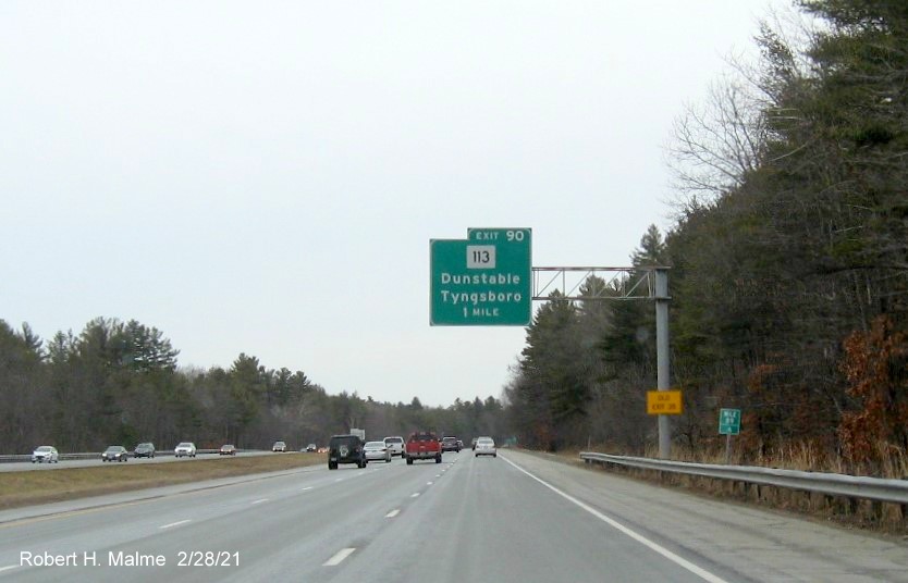 Image of 1-mile advance overhead sign for MA 113 exit with new milepost based exit number and yellow old exit number sign on right support post on US 3 South in Tyngsborough, February 2021
