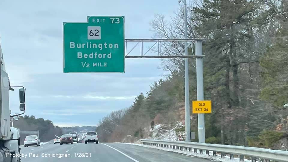 Image of 1/2 mile advance overhead sign for MA 62 exit with new milepost based exit number and yellow old exit sign on support post on US 3 North in Bedford, by Paul Schlichtman, January 2021
