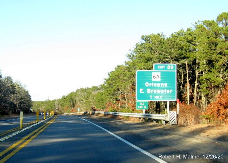 The 1-mile advance sign for the MA 6A exit with new milepost based exit number and green old exit number sign 
                                       on left support post on US 6 East in Orleans, December 2020