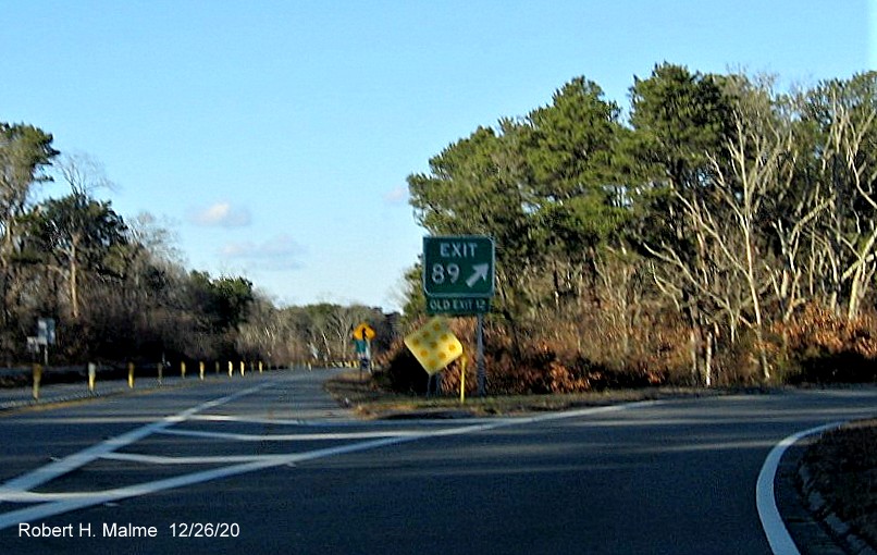 Gore sign for the MA 6A exit with new milepost based exit number and green old exit number sign on bottom on US 6 East in Orleans, December 2020