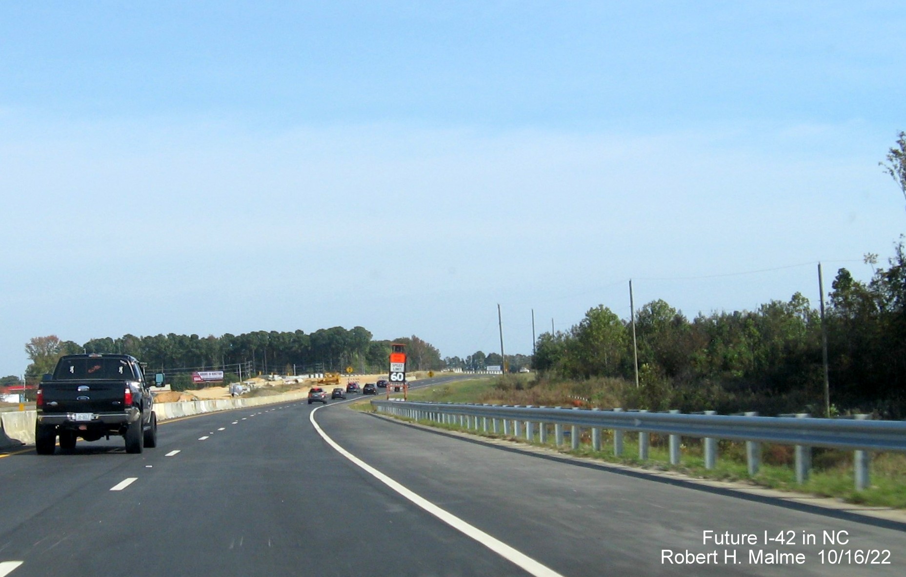 Image of completed future I-42 East right lanes and shoulder and guardrail approaching Wilson Mills Road in Wilson Mills, October 2022