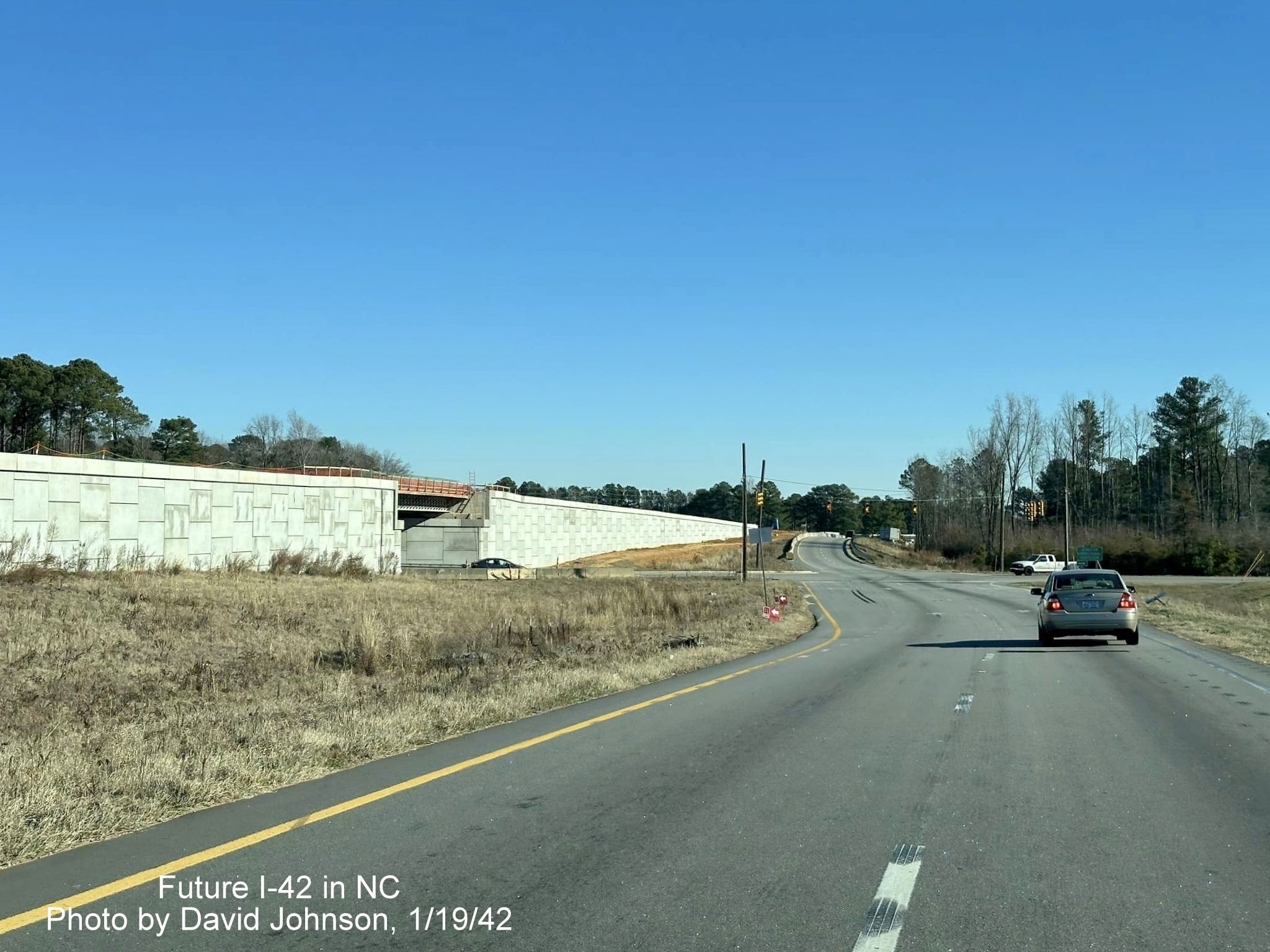 Image of traffic on US 70 (Future I-42) East at traffic light on temporary roadway at Wilson's Mills
        Road, photo by David Johnson, January 2024