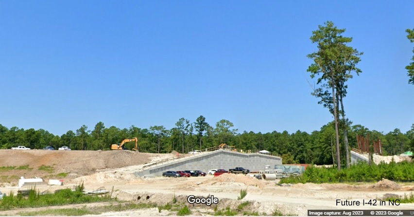 Image of US 70 East lanes at future site of eastbound ramp under western end of Havelock Bypass (Future I-42), Google Maps Street View, August 2023