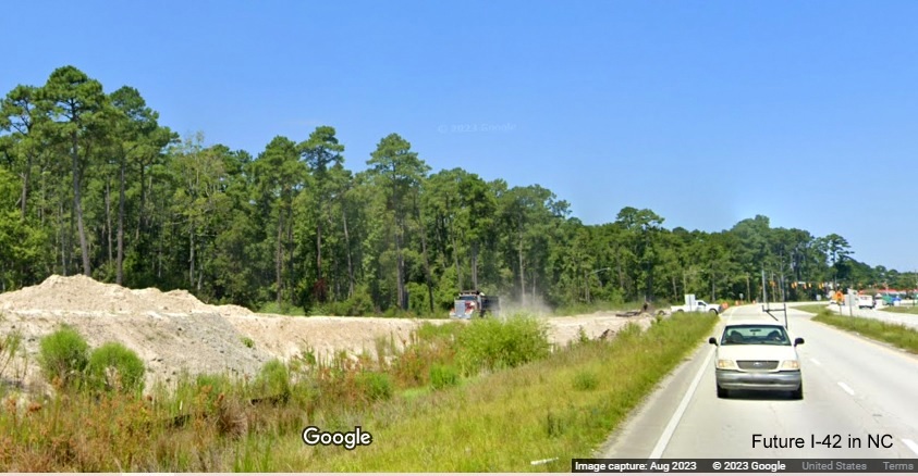 Image from US 70 East lanes of future lanes that will cross over westbound lanes of the Havelock Bypass (Future I-42), Google Maps Street View, August 2023