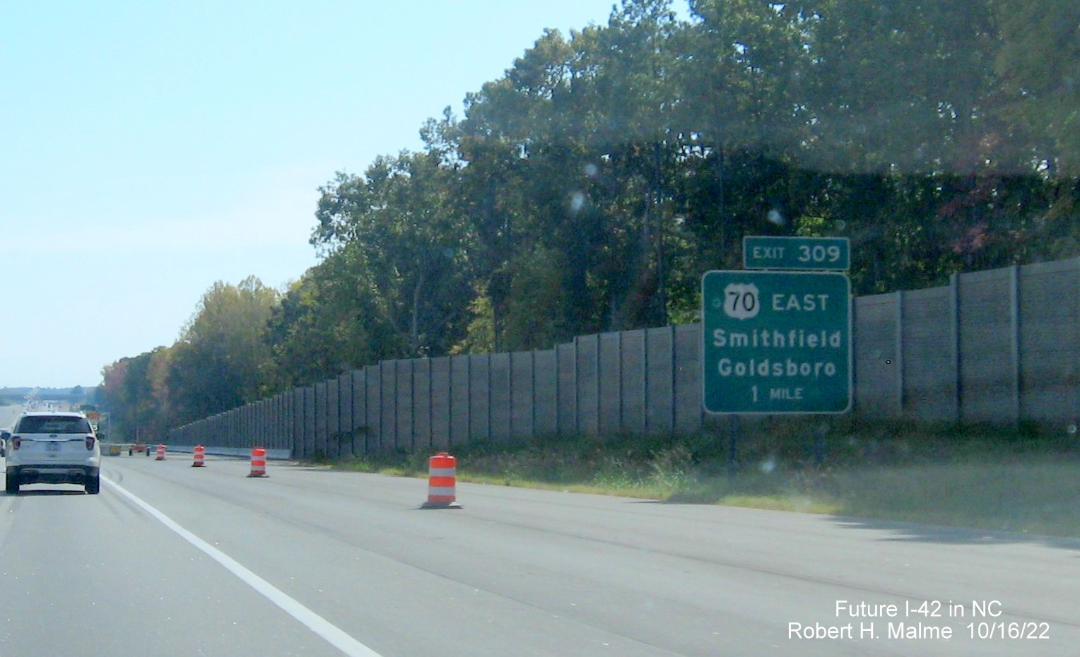 Image of ground mounted 1 mile advance sign for US 70 (Future I-42) East Clayton Bypass on I-40 East in widening zone construction area, October 2022