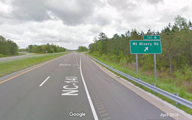 Google Maps Street View image of ground mounted exit ramp sign for Mt Misery Road in Leland, taken in April 
                                      2019