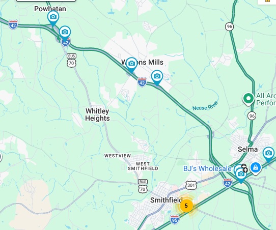 NCDOT traffic camera image of blue services sign for the Swift Creek Road exit with
US 70 milepost exit number on US 70 (Future I-42) East in Wilson's Mills, June 2026