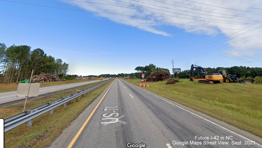 Image of construction vehicles at site of future interchange at Wilson Mills Road from US 70 East, Google Maps Street View image, September 2021