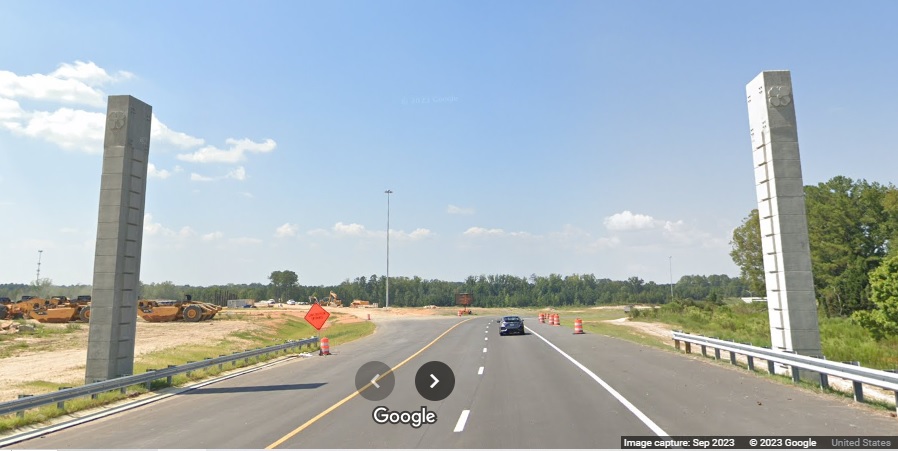 Image of new overhead posts for future signs at new ramps for I-40 East and West in NC 540 Toll/Triangle Expressway in Garner, Google Maps Street View, September 2023