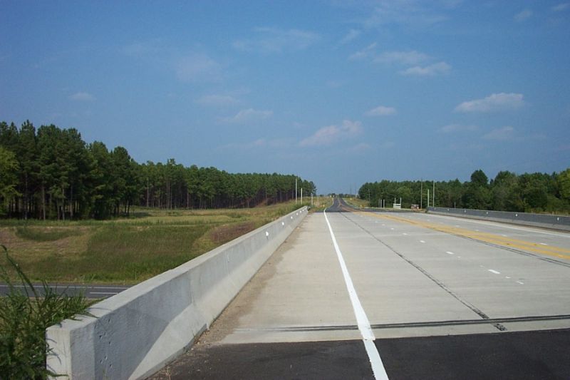 Photo of Tabernacle Church Rd bridge over Future I-73/I-74 showing signposts, 
but no signs, Aug. 2007