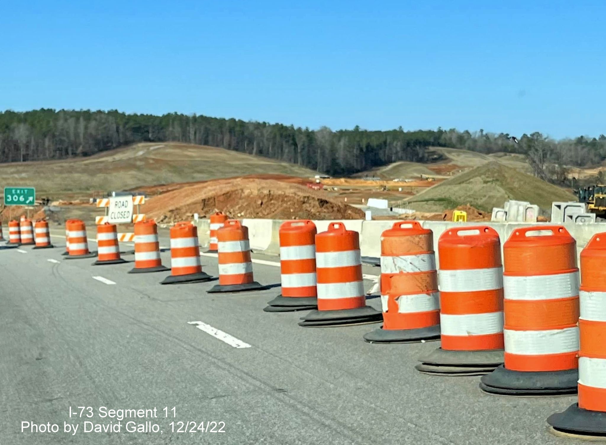 Image of construction barrels along US 74 West at former US 74 Business off-ramp, 
                                            photo by David Gallo, December 2022