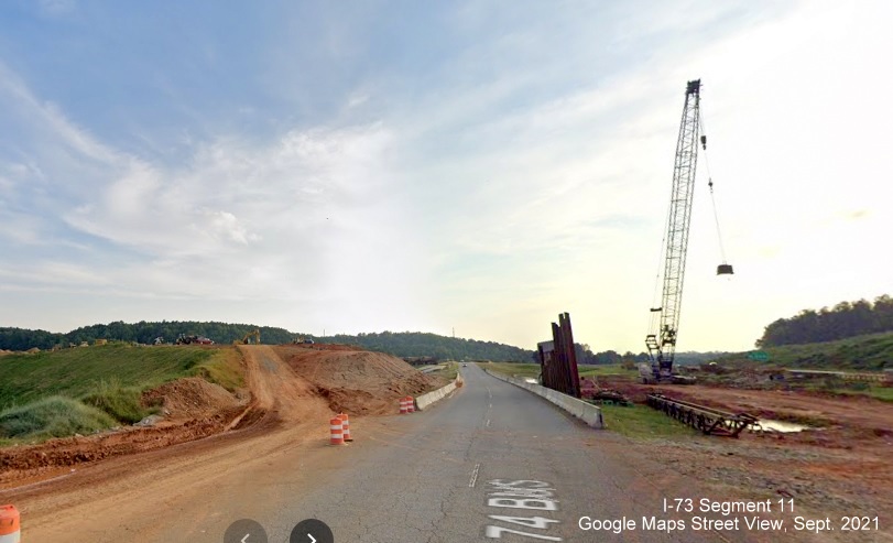 Image of US 74 Business passing site of future bridge being constructed as part of future I-73/I-74 Rockingham Bypass ramp from US 74, Google 
        Maps Street View image, September 2021