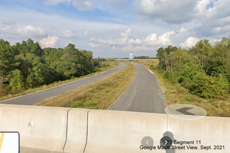 Image of view looking northeast from Harrington Road bridge over future I-73/I-74 
        Rockingham Bypass toward end at US 220, Google Maps Street View image, September 2021