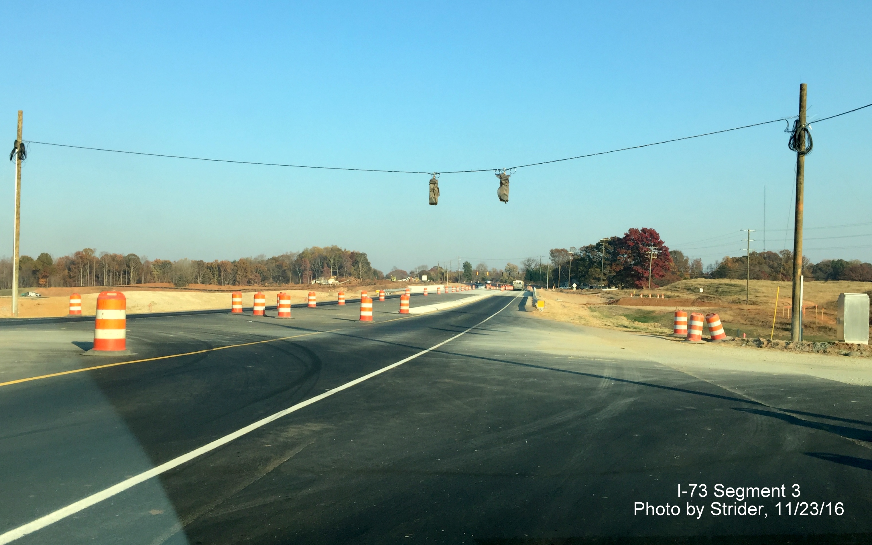 Image looking east at future ramp to I-73 South from NC 150 near Summerfield showing installation of traffic lights, from 
              Strider