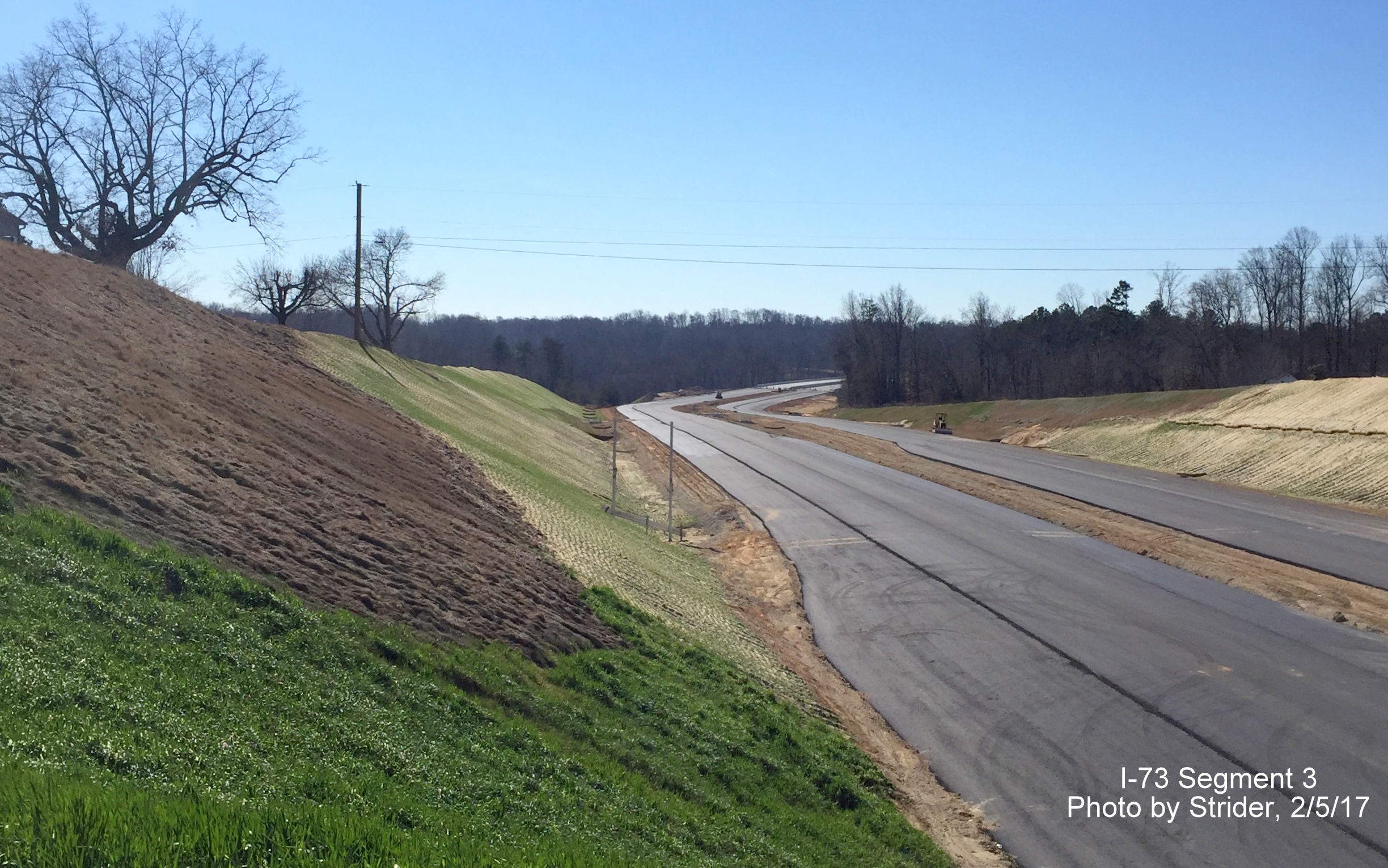 Image of view looking south from Brookbank Rd bridge, showing progress in paving future I-73 lanes, from Strider