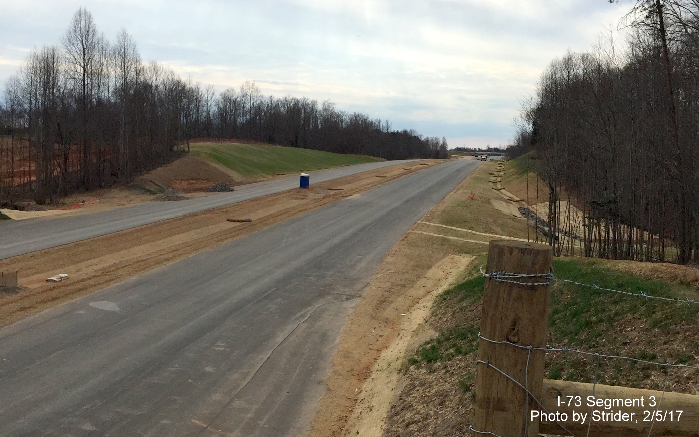 Image of view looking south from Deboe Rd bridge showing progress completing future I-73 lanes, from Strider