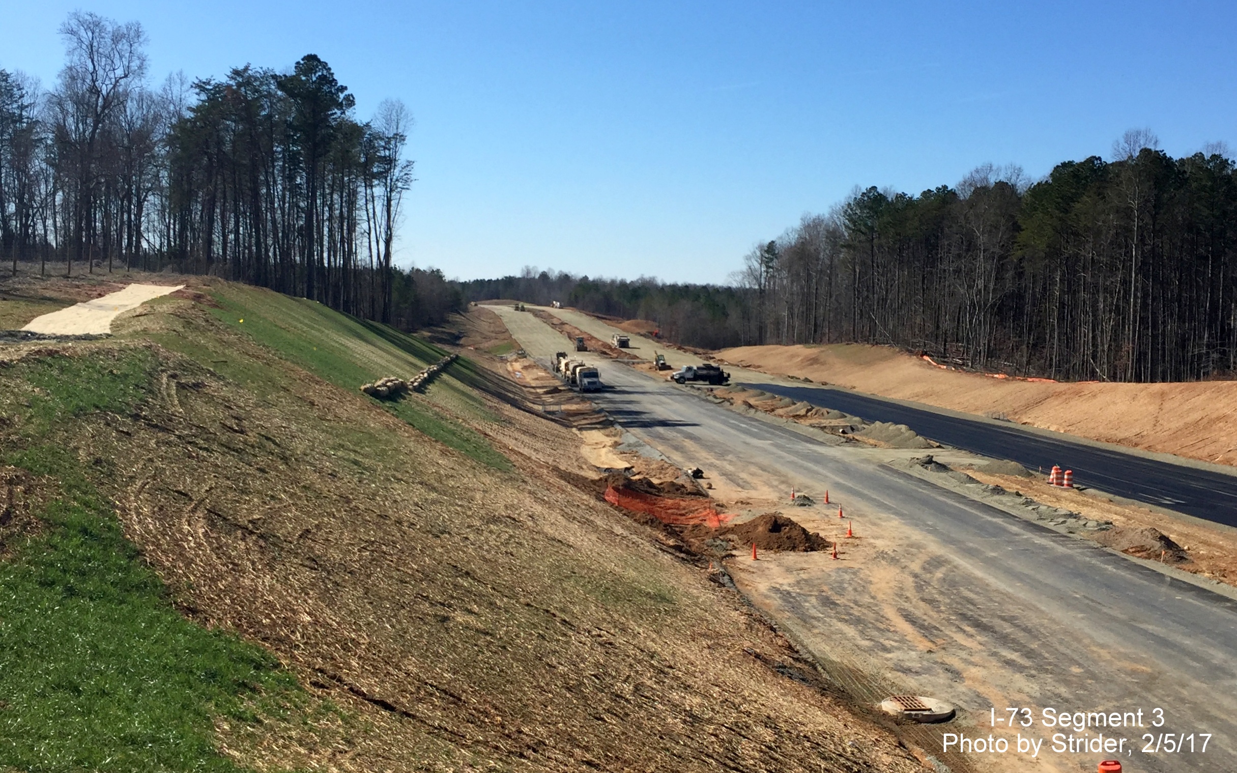 Image of view looking south from Bunch Rd showing long delayed progress in paving future I-73 lanes, from Strider