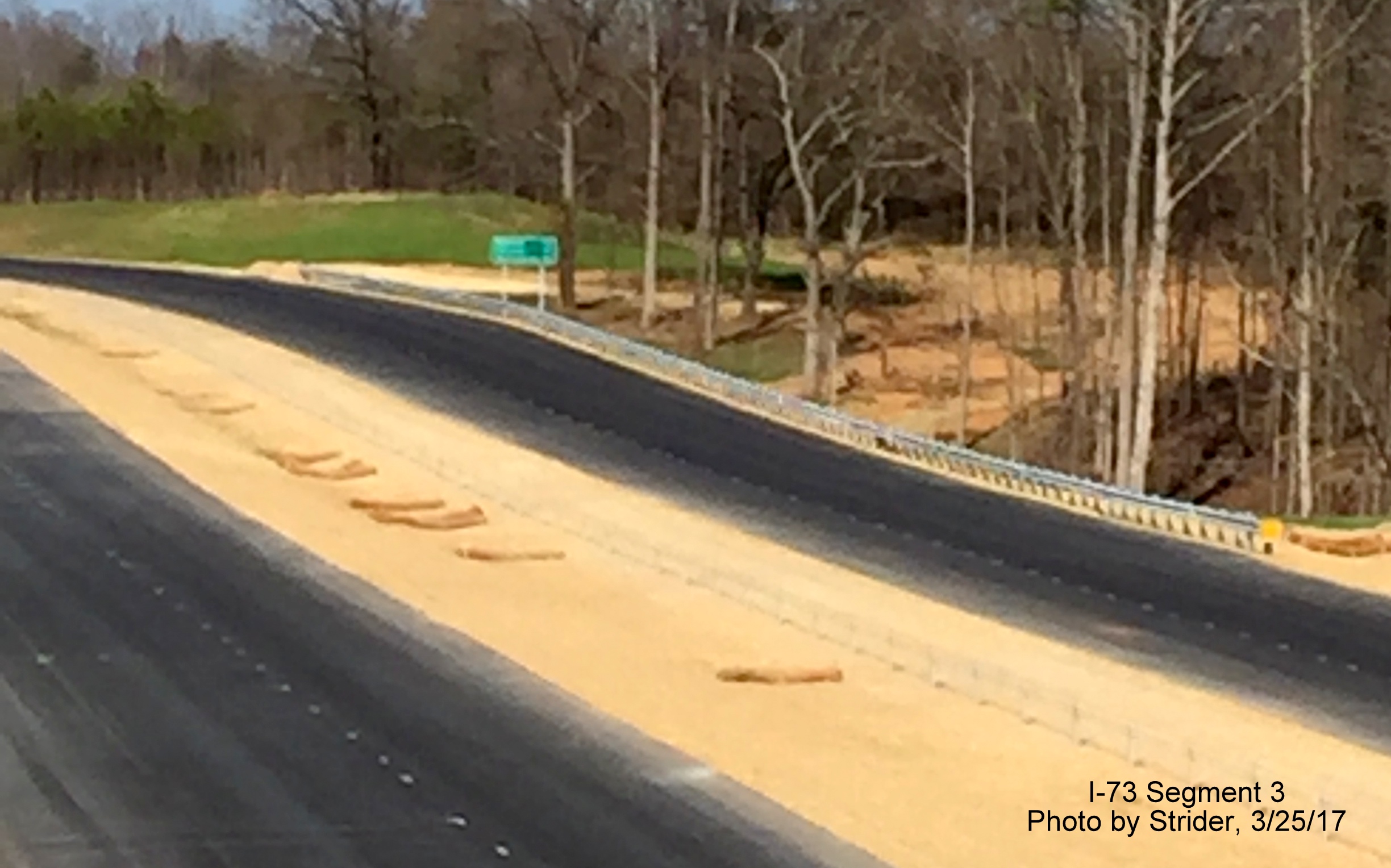 Image of future I-73 lanes showing installed destination distance sign, from Strider
