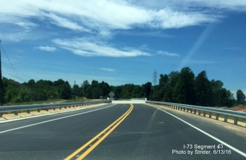 Image of newly completed Alcorn Road bridge over future I-73 roadway, from Strider