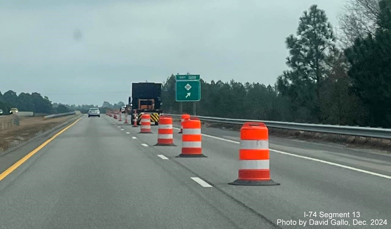 Image of new ramp sign for NC 381 exit going up in front of old sign on US 74 
	  (Future I-74) East in Hamlet, by David Gallo, December 2024