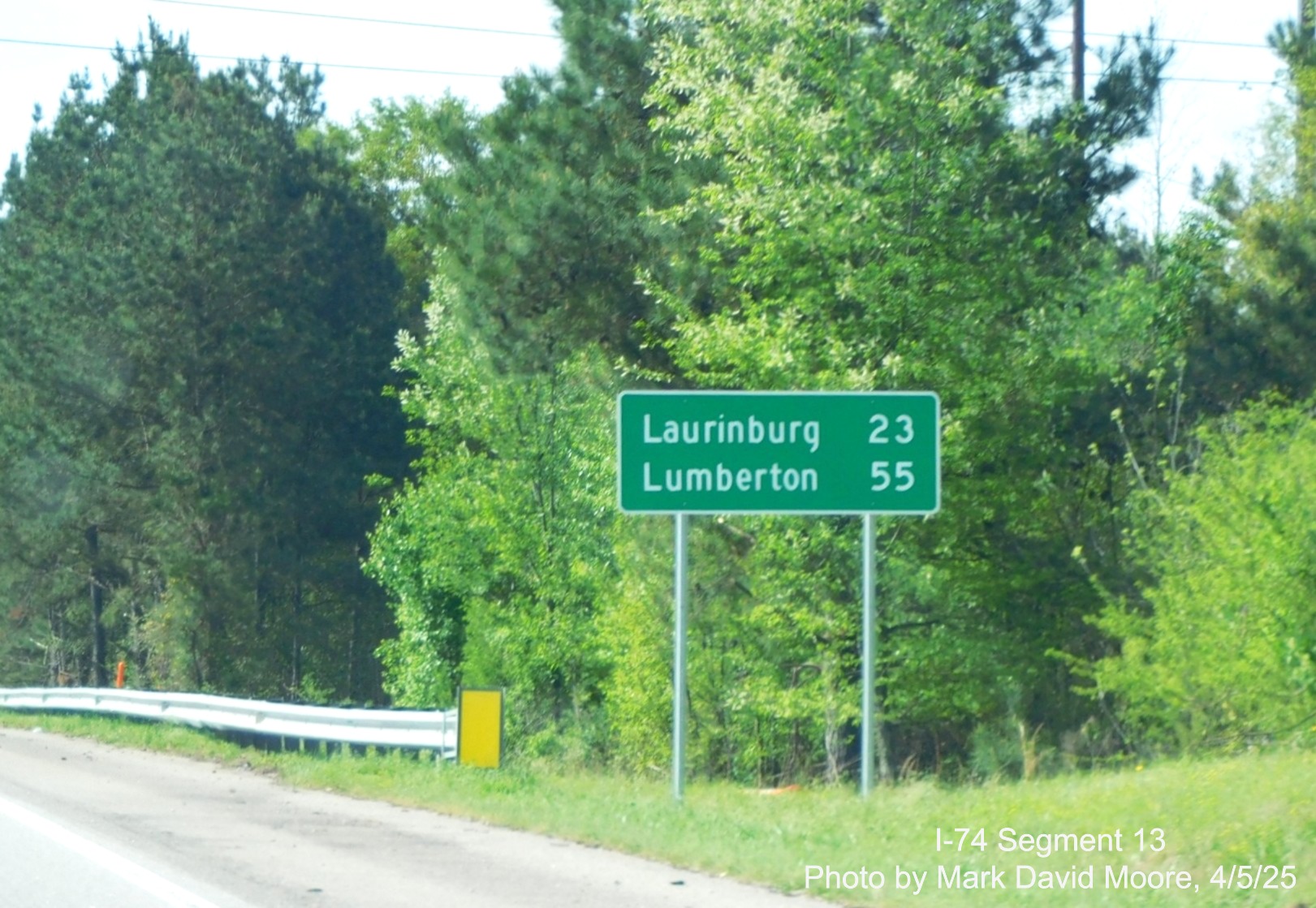 Image of new post interchange distance sign after the US 1 exit on I-74/US 74 East in
		Rockingham by Mark David Moore, April 2025