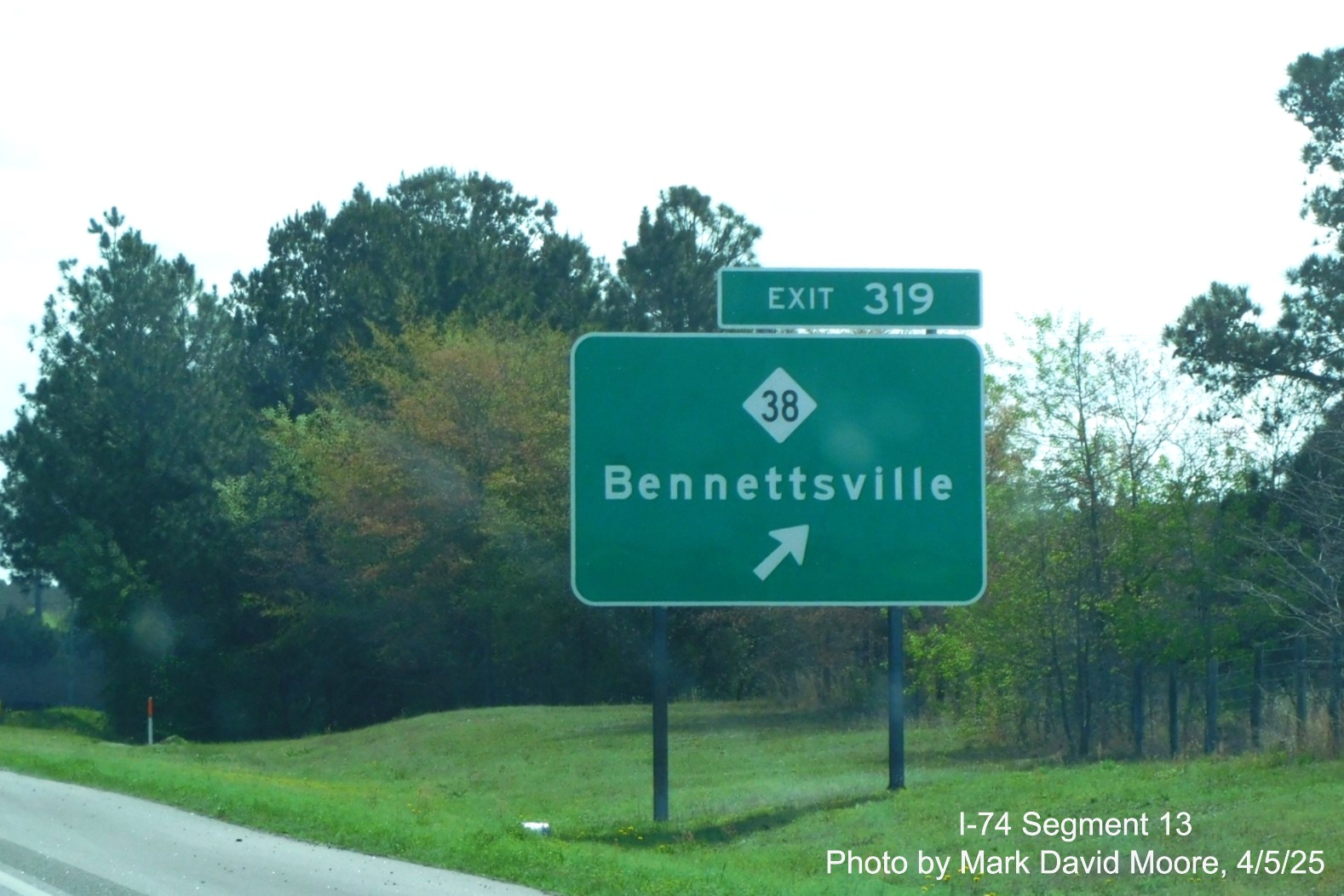 Image of new ground mouted ramp sign for the NC 38 exit on I-74/US 74 East in
		Hamlet by Mark David Moore, April 2025