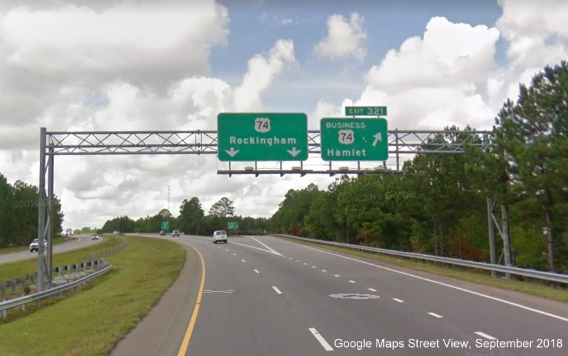Google Maps Street View image of overhead exits signs at ramp to Business 74 West
        on US 74/Future I-74 West in Hamlet, taken in September 2018