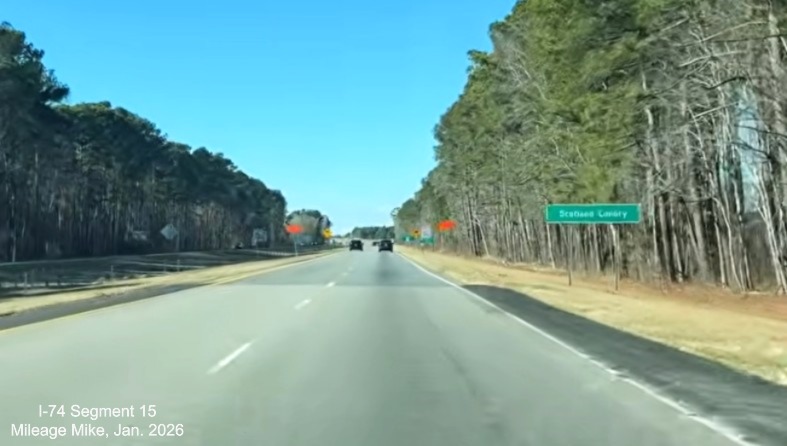 Image of newly paved shoulders on both sides of US 74 (Future I-74) West ending 
	  at the Scotland county line, screen grab from Mileage Mike video, January 2026