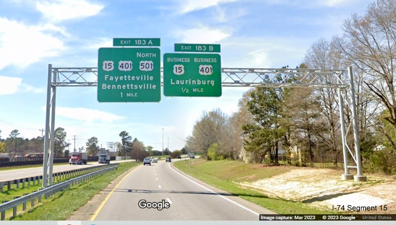 Image of new 1 mile advance overhead sign for US 15, US 401 and US 501 North exit and 1/2 Mile for
        Business 15/401 exit on US 74 (Future I-74) West in Laurinburg, Google Maps Street View, March 2023
