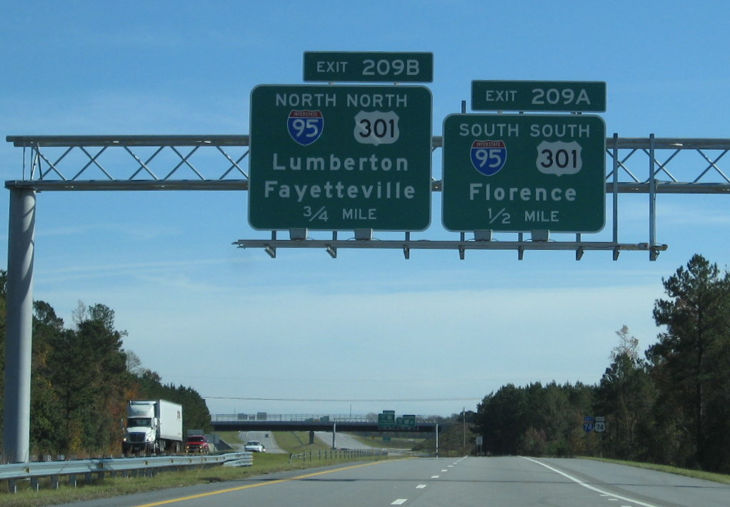 Photo of first set of overhead signs on I-74 East for I-95/US 301 exit near 
Lumberton, Nov. 2009