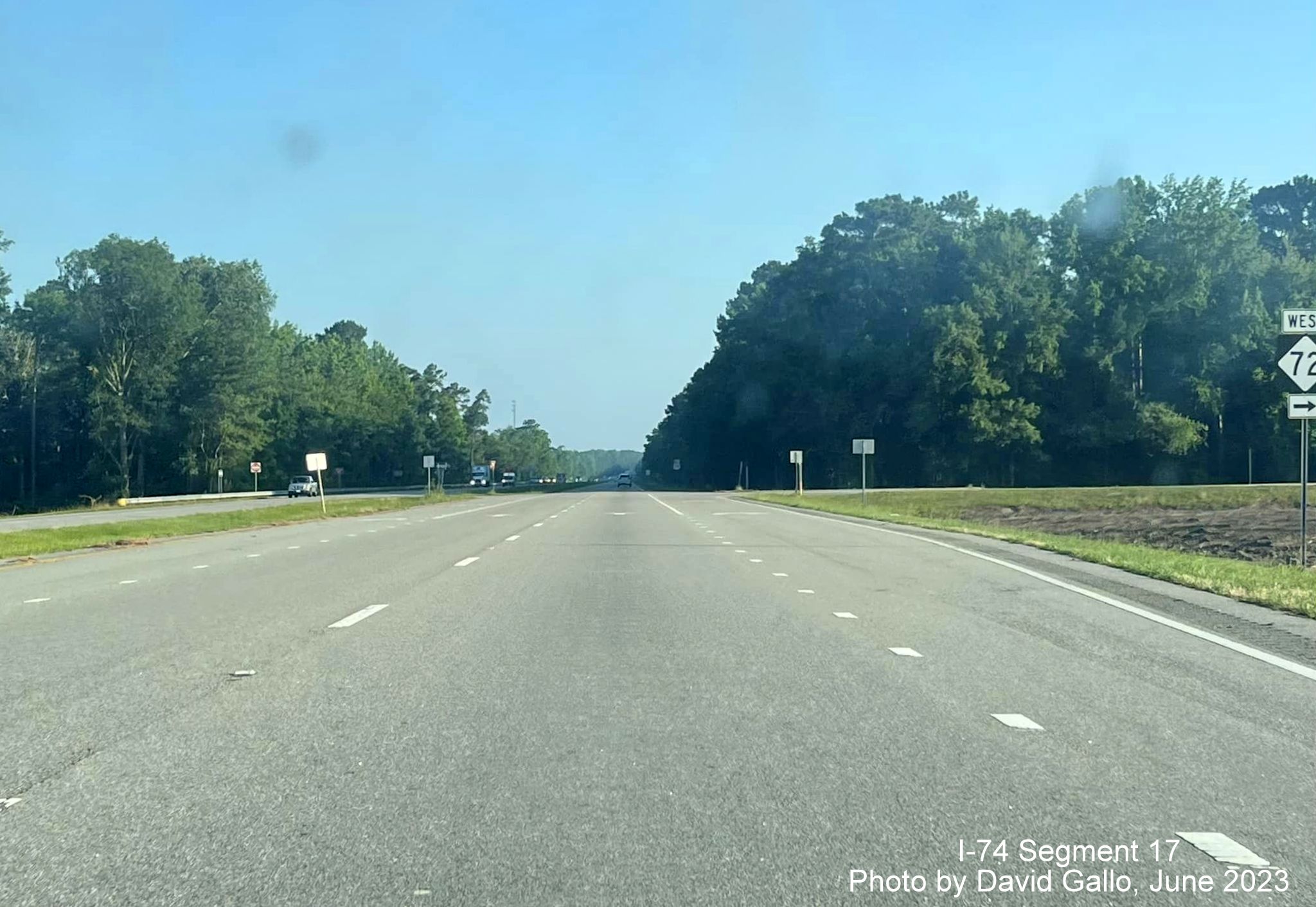 Image of NC 72 trailblazer approaching current intersection on US 74 
       (Future I-74) West, by David Gallo, June 2023