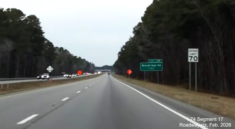Image approaching Broadridge Road exit on US 74 (Future I-74) West in 
	  Robeson County, showing road construction signage and new Speed Limit 70 sign. Google Maps Street View, February 2026