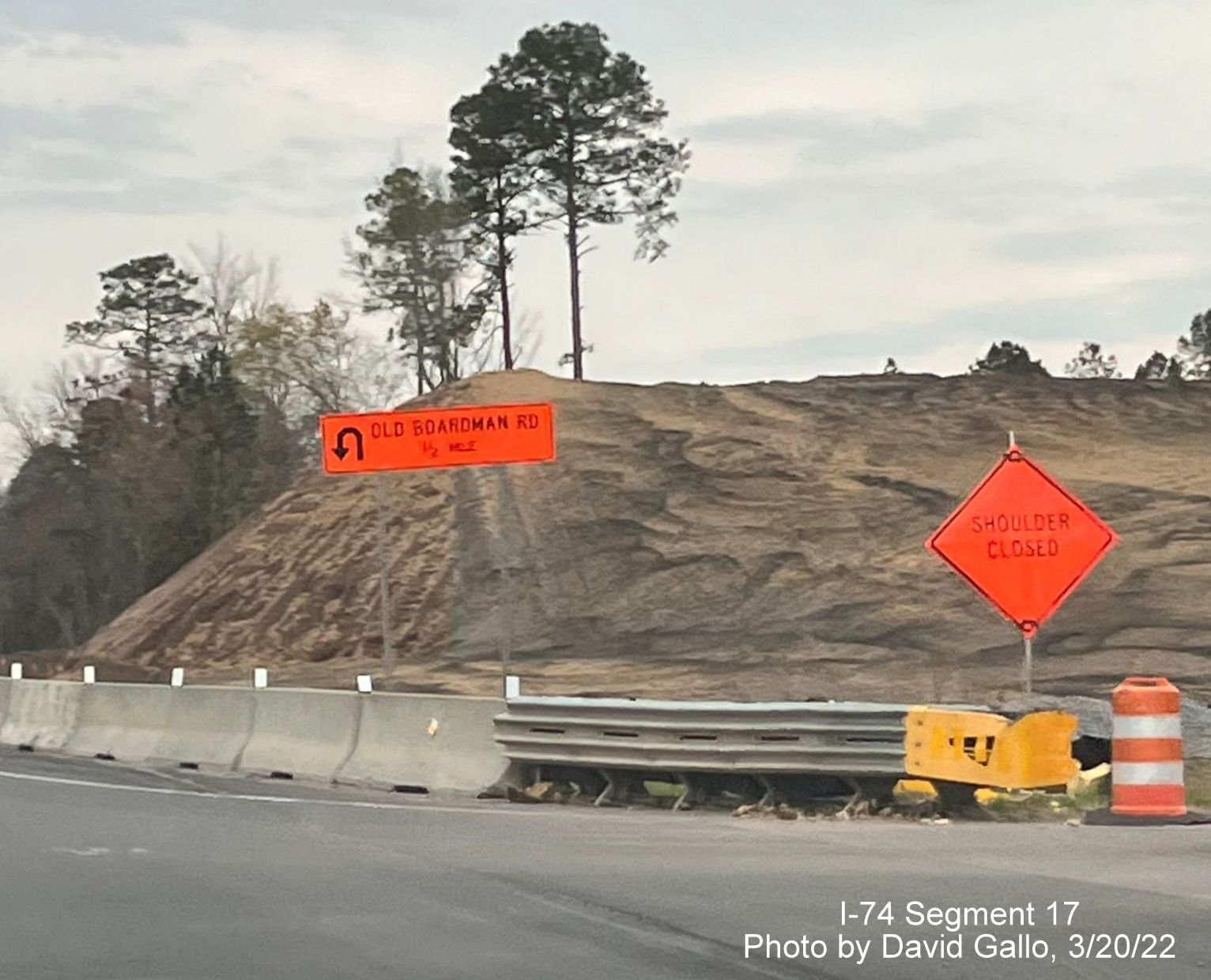 Image of approaching embankment being built for future Old Boardman Road bridge over US 74 (Future I-74), 
        by David Gallo, March 2022