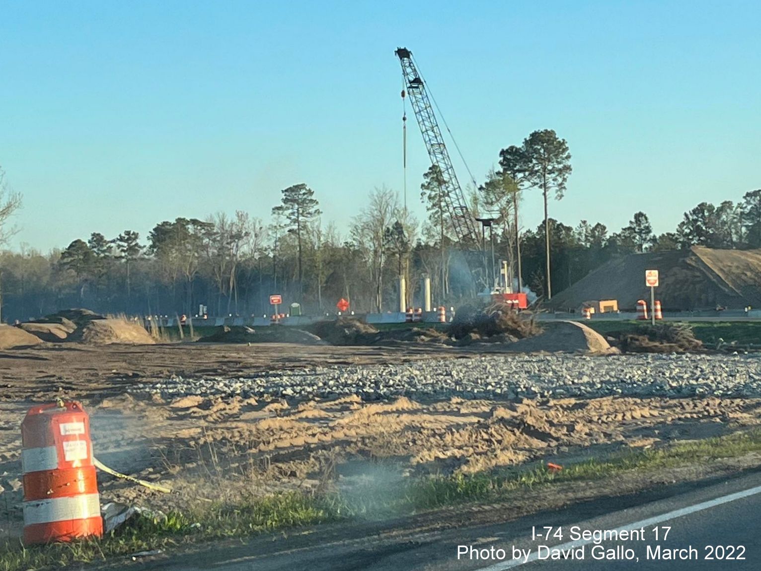 Image from Old Boardman Road of crane helping construct supports for future Boardman interchange bridge 
        on US 74 (Future I-74) West, by David Gallo, March 2022
