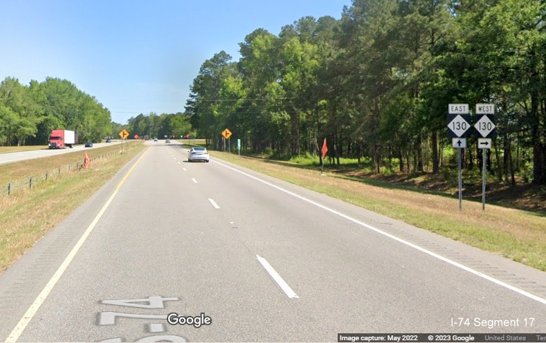 Image of West NC 130 trailblazer approaching intersection, site of future interchange, on US 
          74 East in Orrum, Google Maps Street View, May 2022