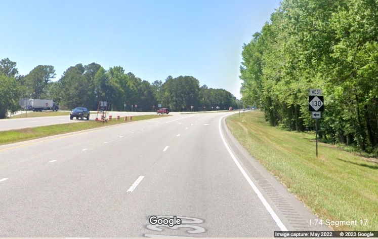 Image of West NC 130 trailblazer approaching intersection, site of future interchange, on US 
          74 West in Orrum, Google Maps Street View, May 2022