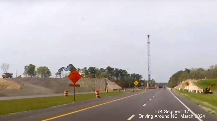 Screen grab image approaching bridge under construction as part of the NC 130/72 West interchange
       project on US 74 (Future I-74) West in Robeson County, Driving Around NC, March 2024