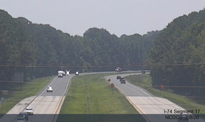 Image from NCDOT traffic camera showing completed 4 foot shoulder widening on US 74
(Future I-74) in Lumberton, NCDOT, June 2026