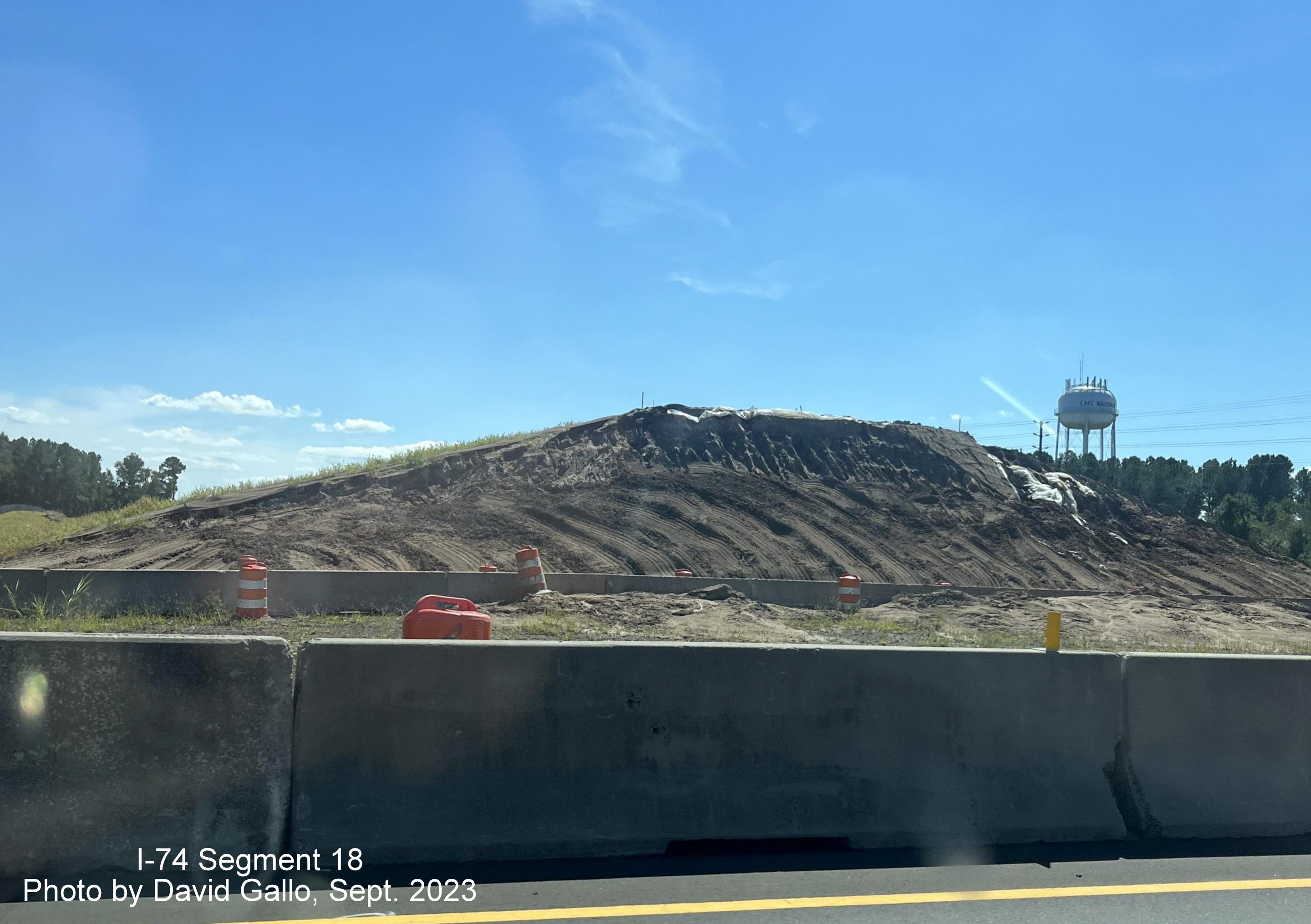 Image of the bridge construction looking across closed median at current Chauncey Town Road intersection on US 74/76 (Future I-74) West in Lake Waccamaw, David Gallo, September 2023