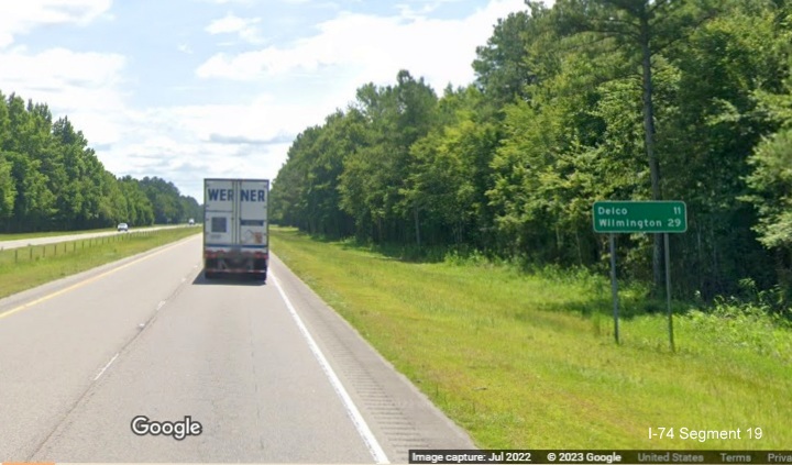 Image of ground mounted post-interchange distance sign of US 74/76
      East listing mileage as 29 miles to Wilmington, located after end of freeway section in Supply, Google Maps Street View, July 2022