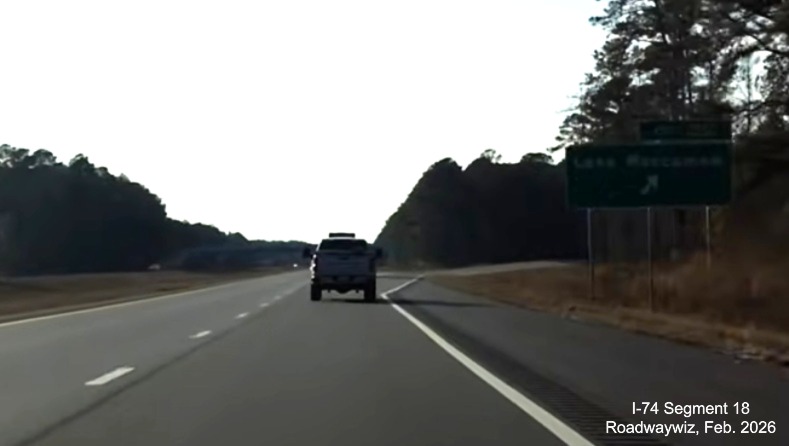 Image of ground mounted ramp sign for Lake Waccamaw exit at Chauncey Town Road 
	   on US 74/76 (Future I-74) West in Columbus County, Screen Grab from Roadwaywiz video, February 2026