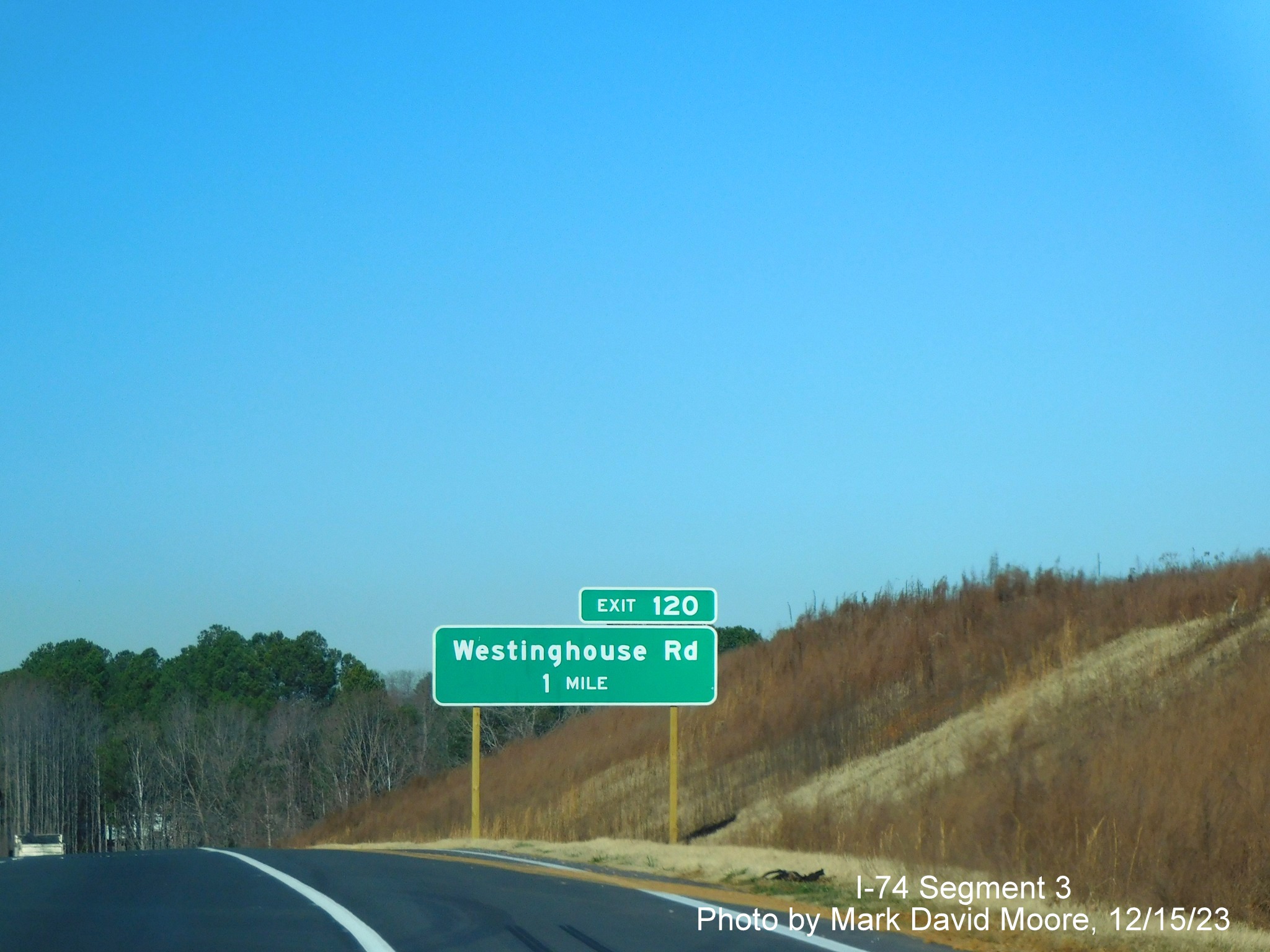 Image of newly placed 1 mile advance sign for the Westinghouse Road exit along the widened 
       portion of US 52 North (Future I-74 West) beyond the Winston-Salem Northern Beltway interchange, by Mark David Moore, December 2023