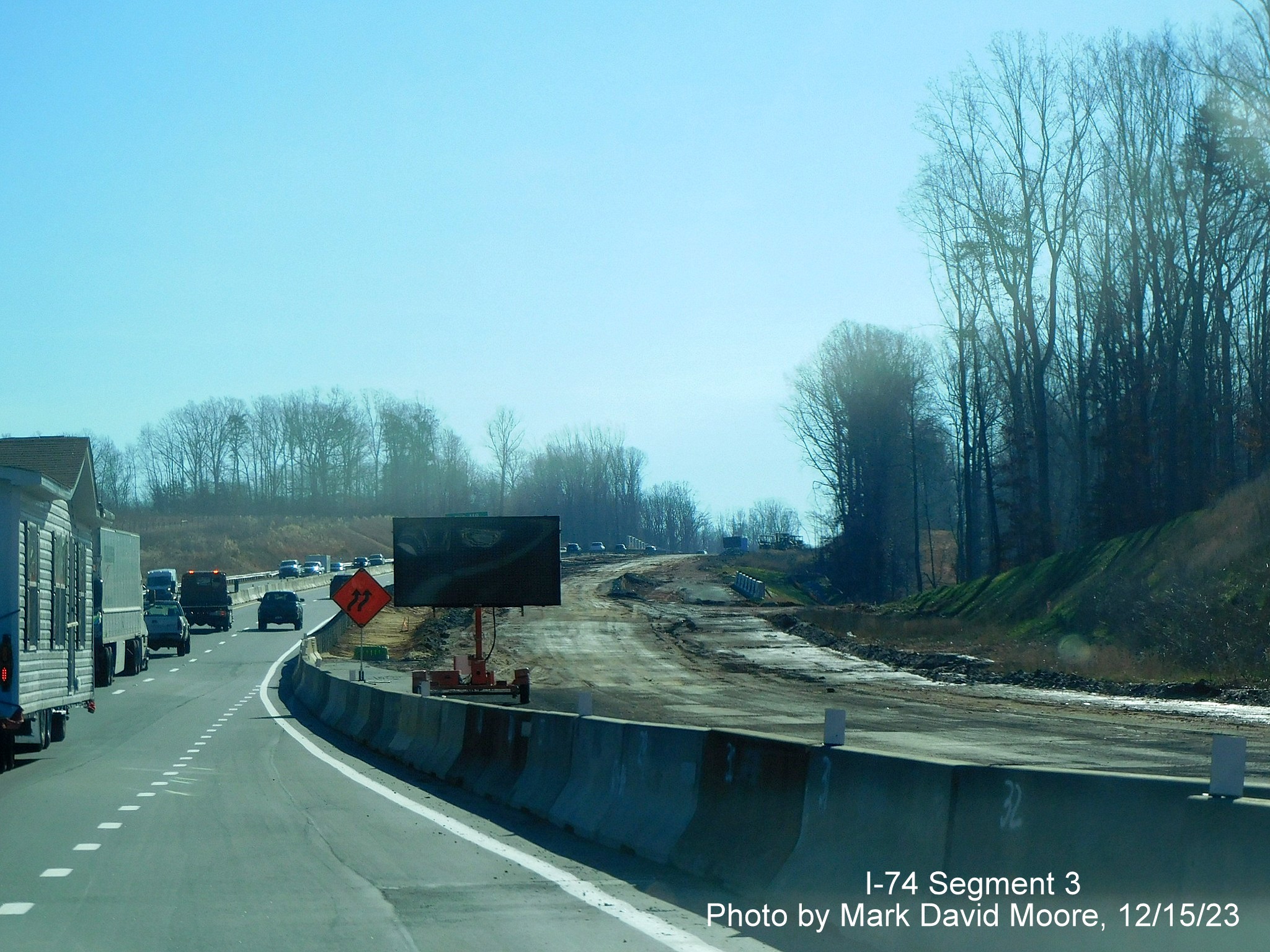 Image of road widening after the Westinghouse Road exit on US 52 South (Future I-74 East) 
        heading towards the Winston-Salem Northern Beltway interchange, by Mark David Moore, December 2023