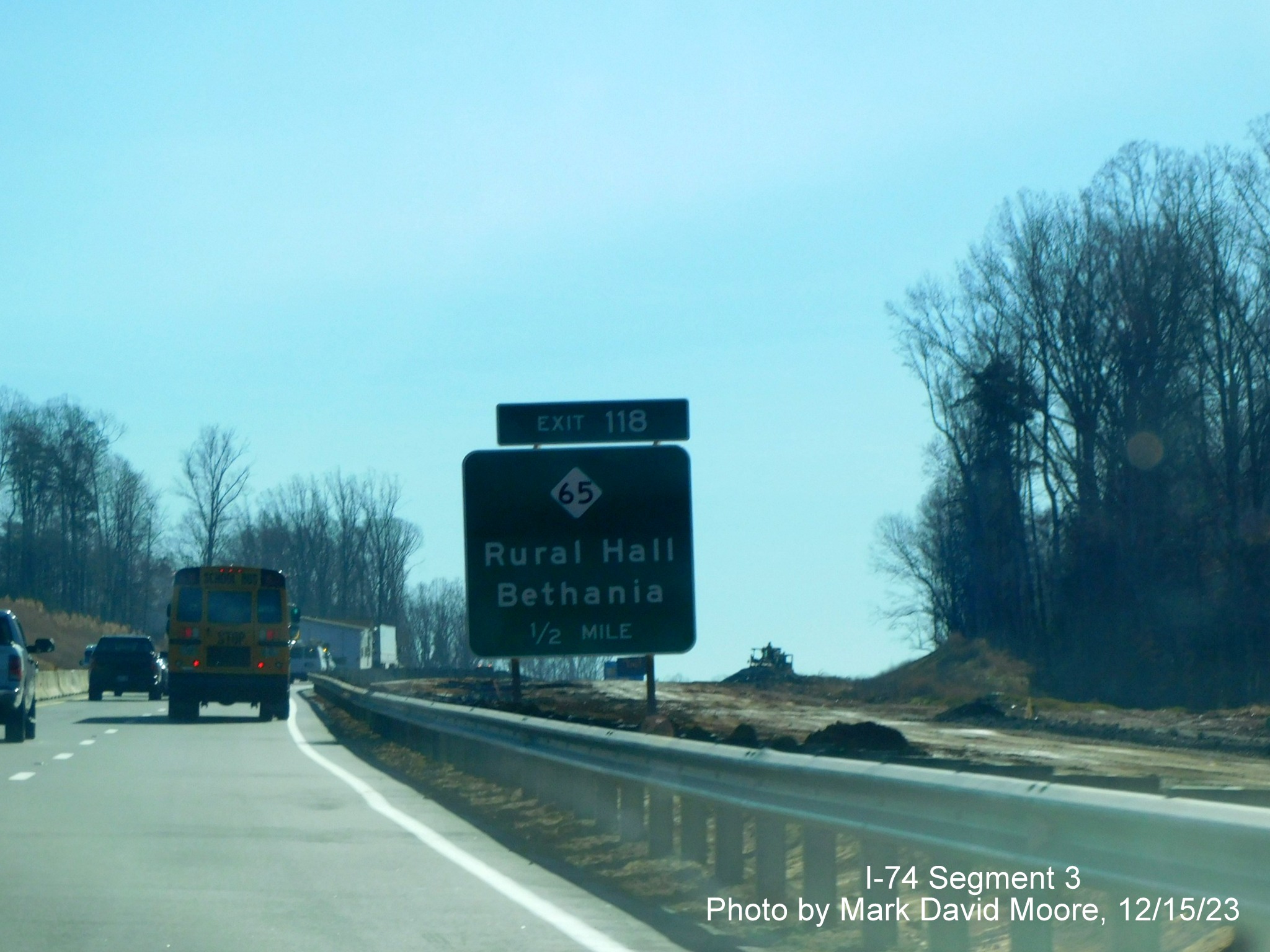 Image of temporarily placed 1/2 mile advance sign for the upcoming NC 65
        exit, by Mark David Moore, December 2023
