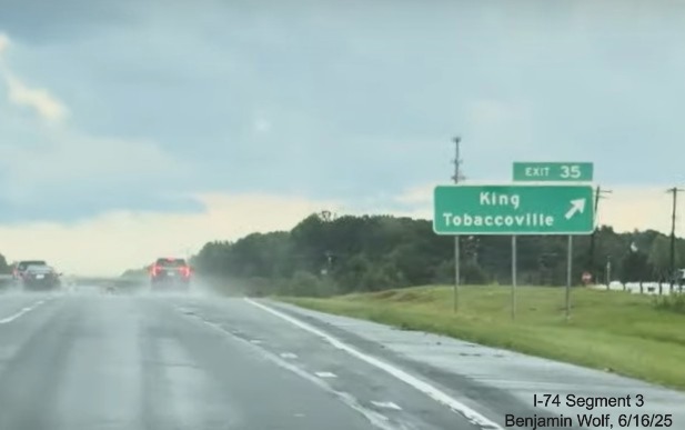 Image of renumbered ground mounted ramp sign for the King/Tobaccoville exit on 
	  US 52 South (Future I-74 East), screen grab from Benjamin Wolf video, June 2025