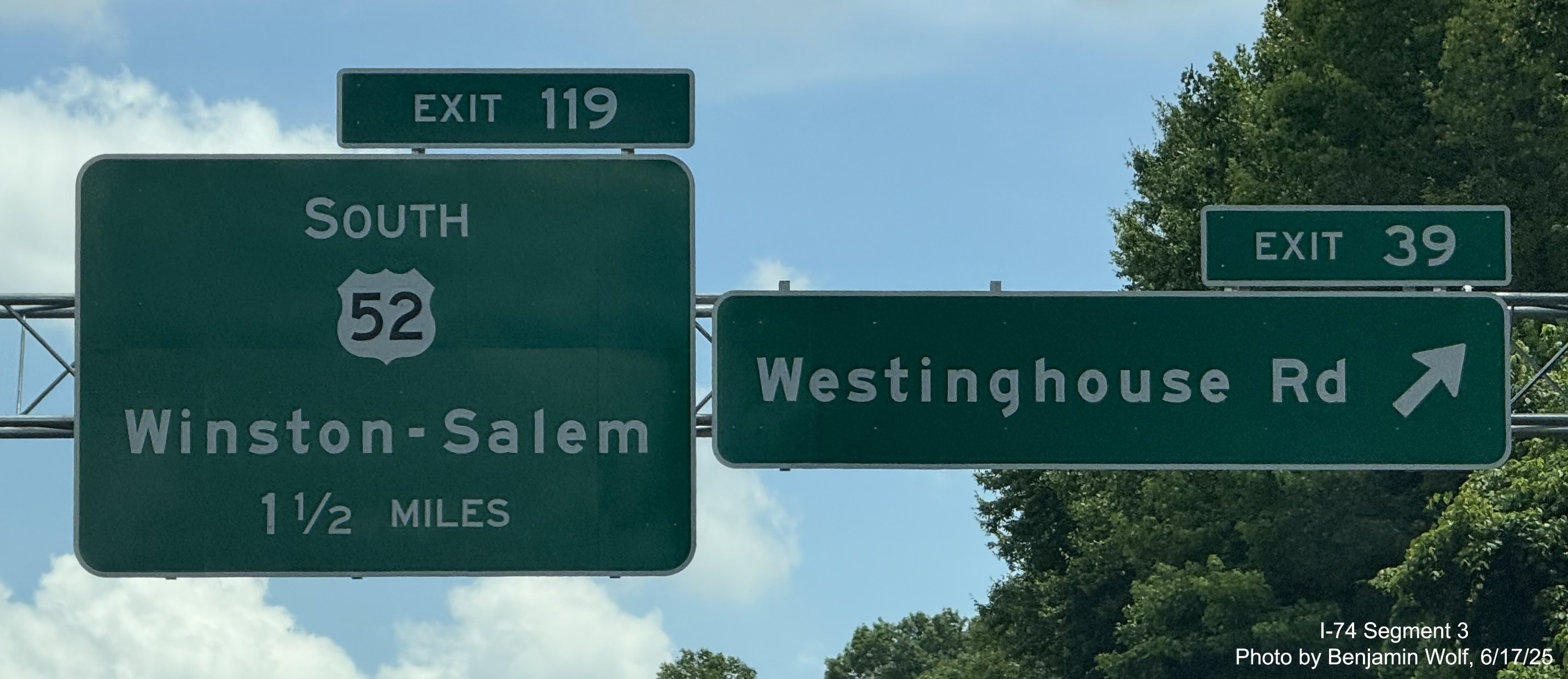Image of renumbered overhead ramp sign for the Westinghouse Road exit on 
	  US 52 South (Future I-74 East), photo by Benjamin Wolf, June 2025