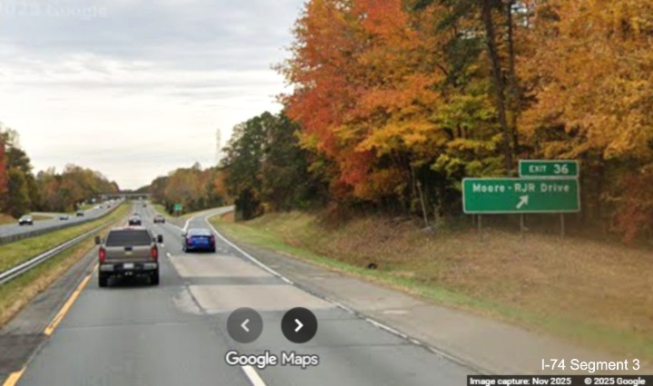 Image of renumbered ground mounted ramp sign for the Moore/RJR Drive exit on 
	  US 52 South (Future I-74 East), Google Maps Street View, November 2025