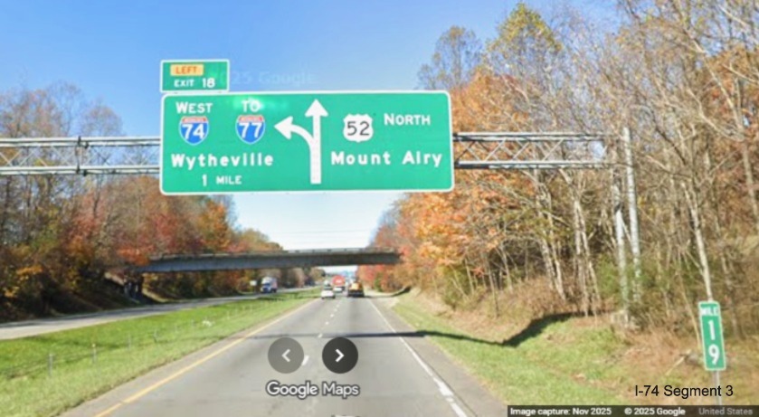 Image of renumbered overhead diagrammatic 1 mile advance sign for the I-74 West
	  exit on US 52 North (Future I-74 West), Google Maps Street View, November 2025
